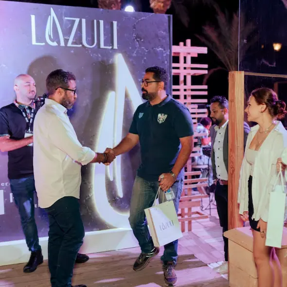 a client in lazuli hurghada shaking hands with one of lazuli teamwork